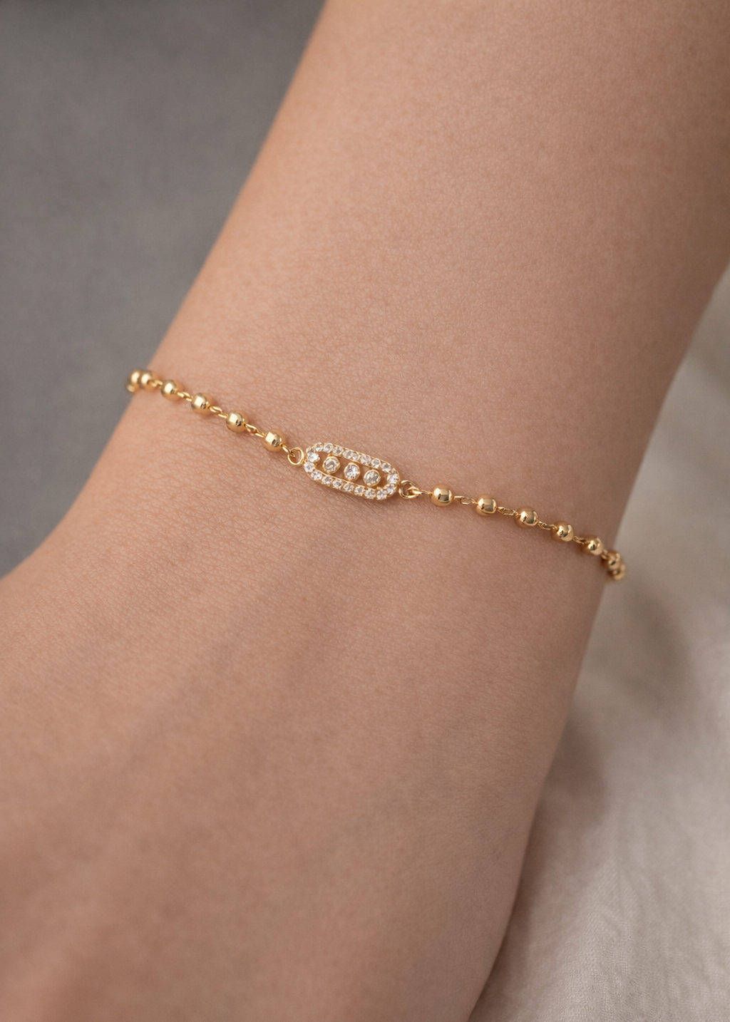 gold plated bracelet with small beads and sparkle centerpiece