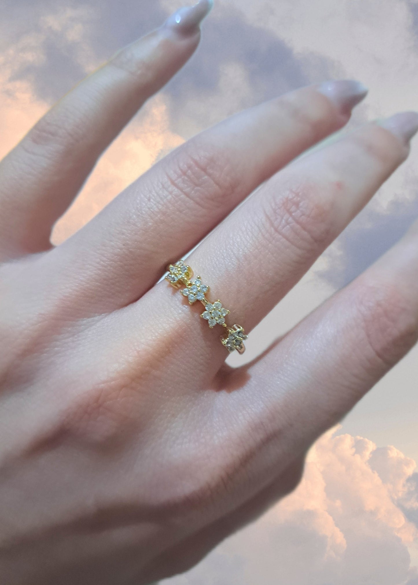 Gold daisy crystal ring with small flower design worn on finger