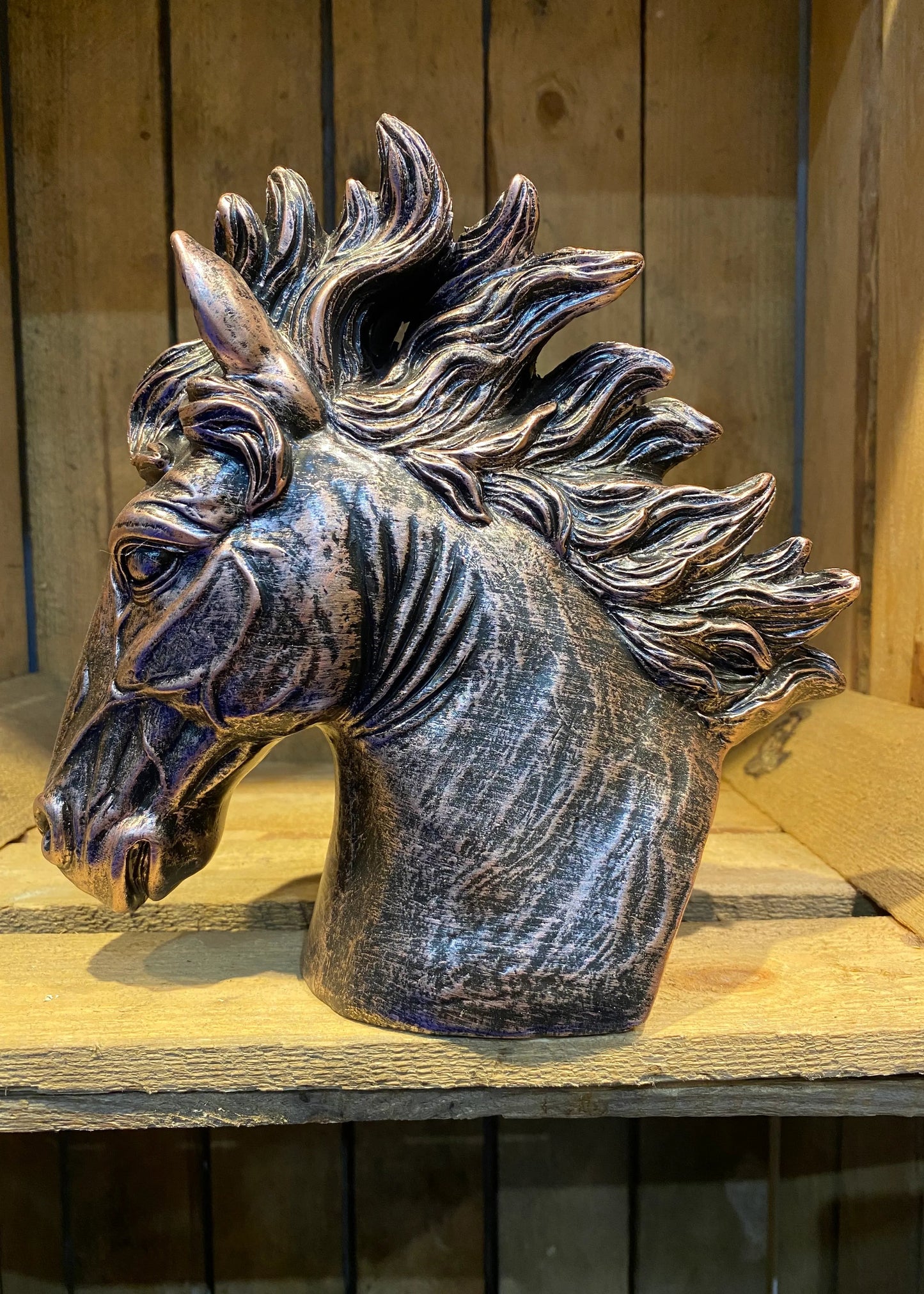 Horse head bronze effect resin sculpture with flowing mane displayed on wooden shelf