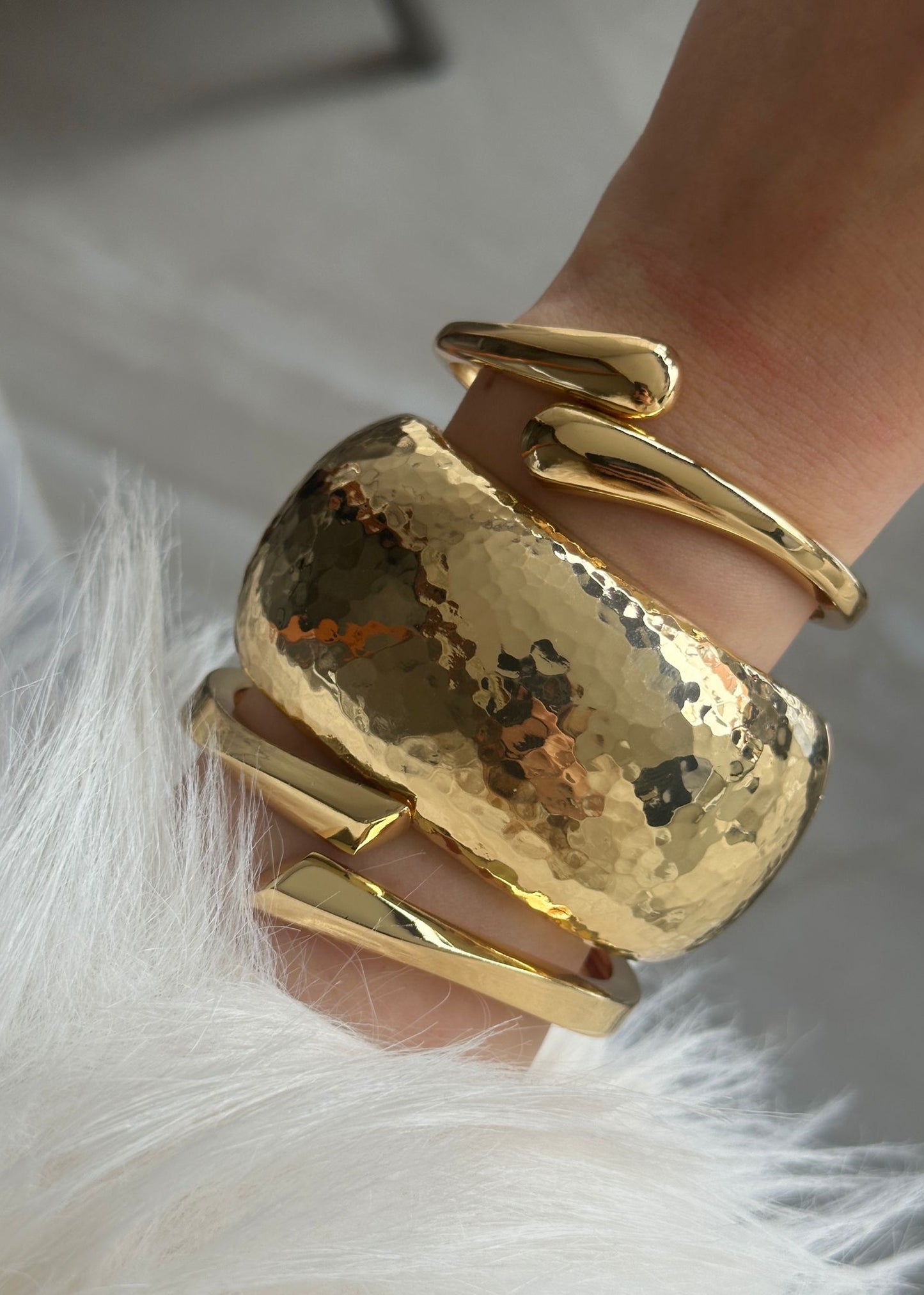 Gold bracelet on a hand with a soft background