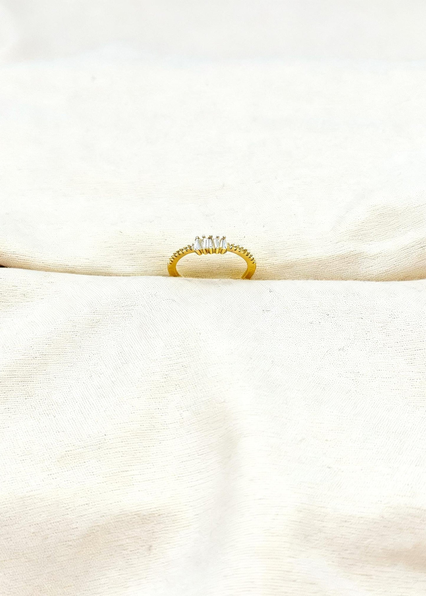 Gold adjustable baguette diamond cluster ring on finger