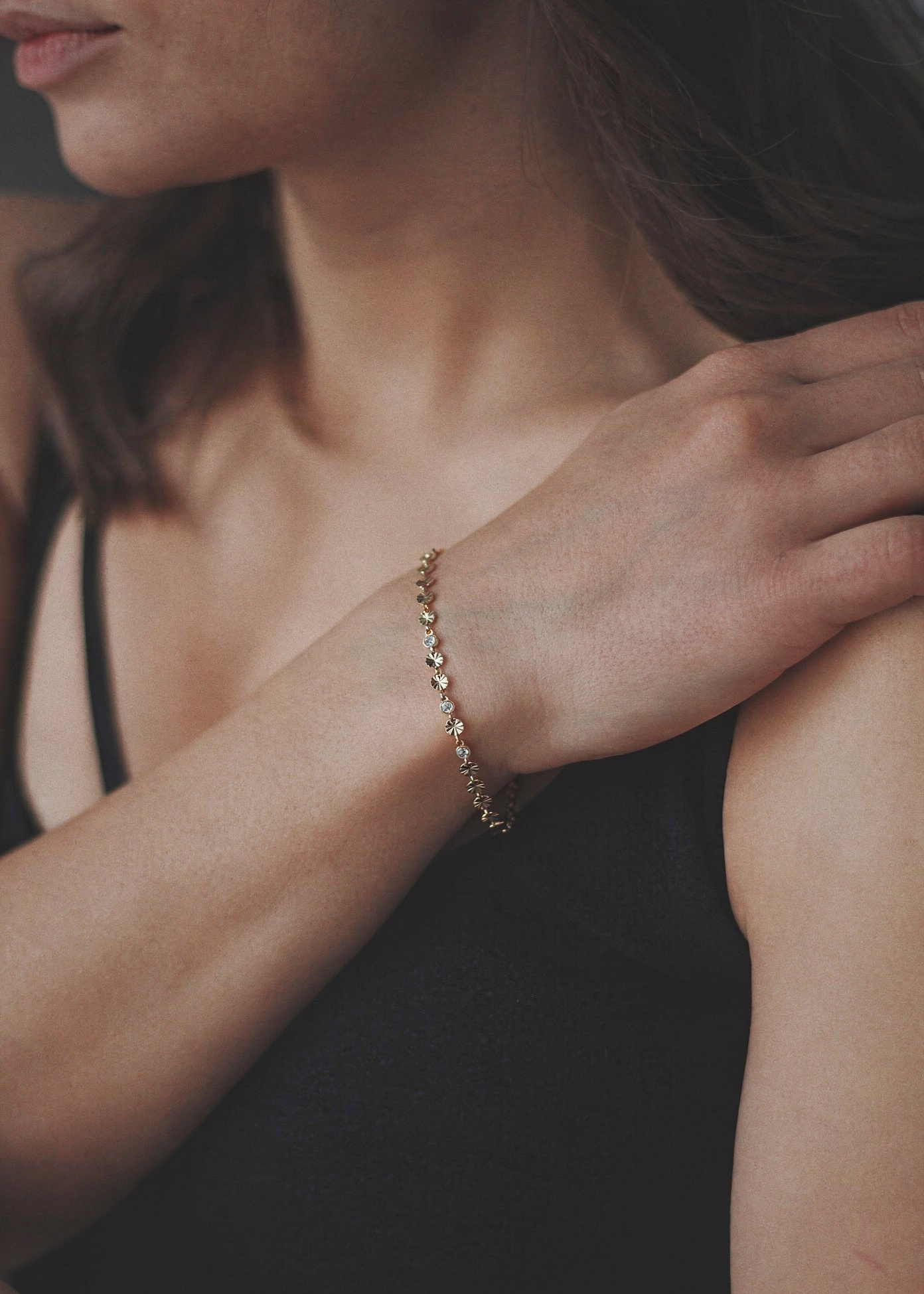 Dainty gold bracelet with textured sparkle discs