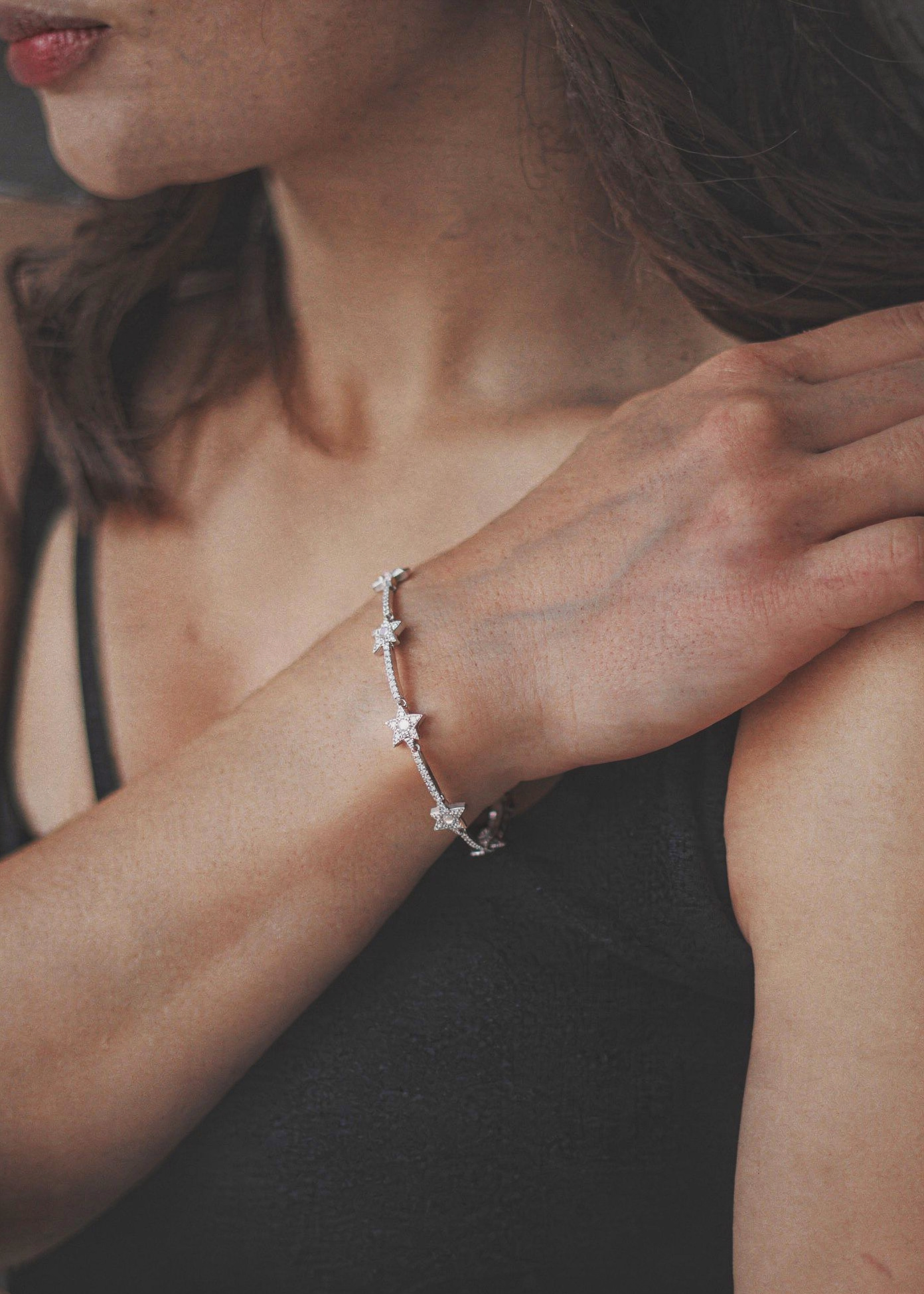 Silver star charm bracelet with adjustable chain on wrist