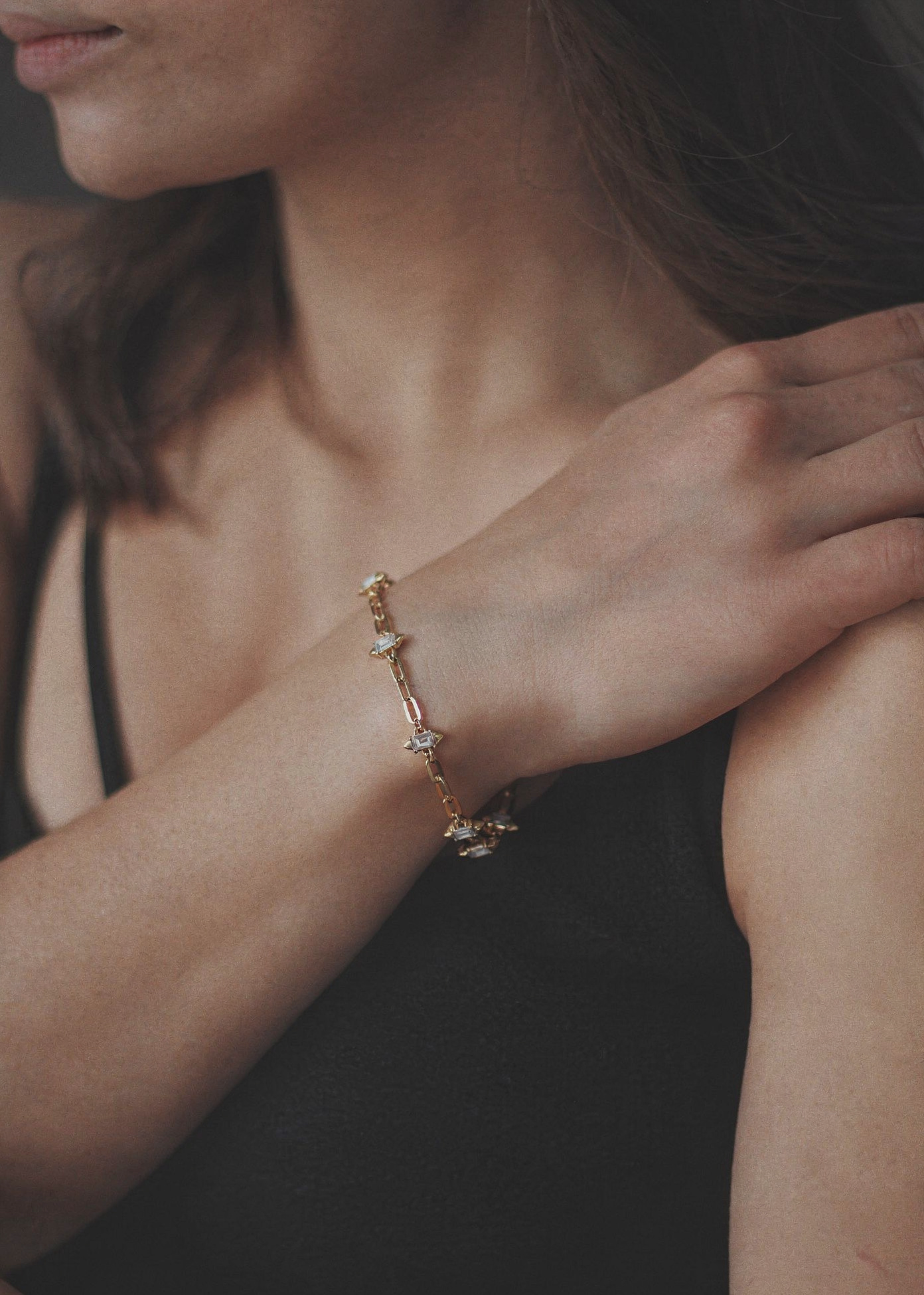 gold charm link bracelet on wrist elegant jewellery