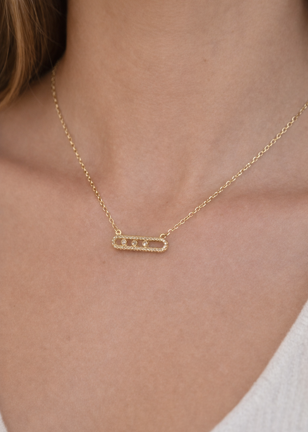 Minimalist gold horizontal bar pendant necklace on neck