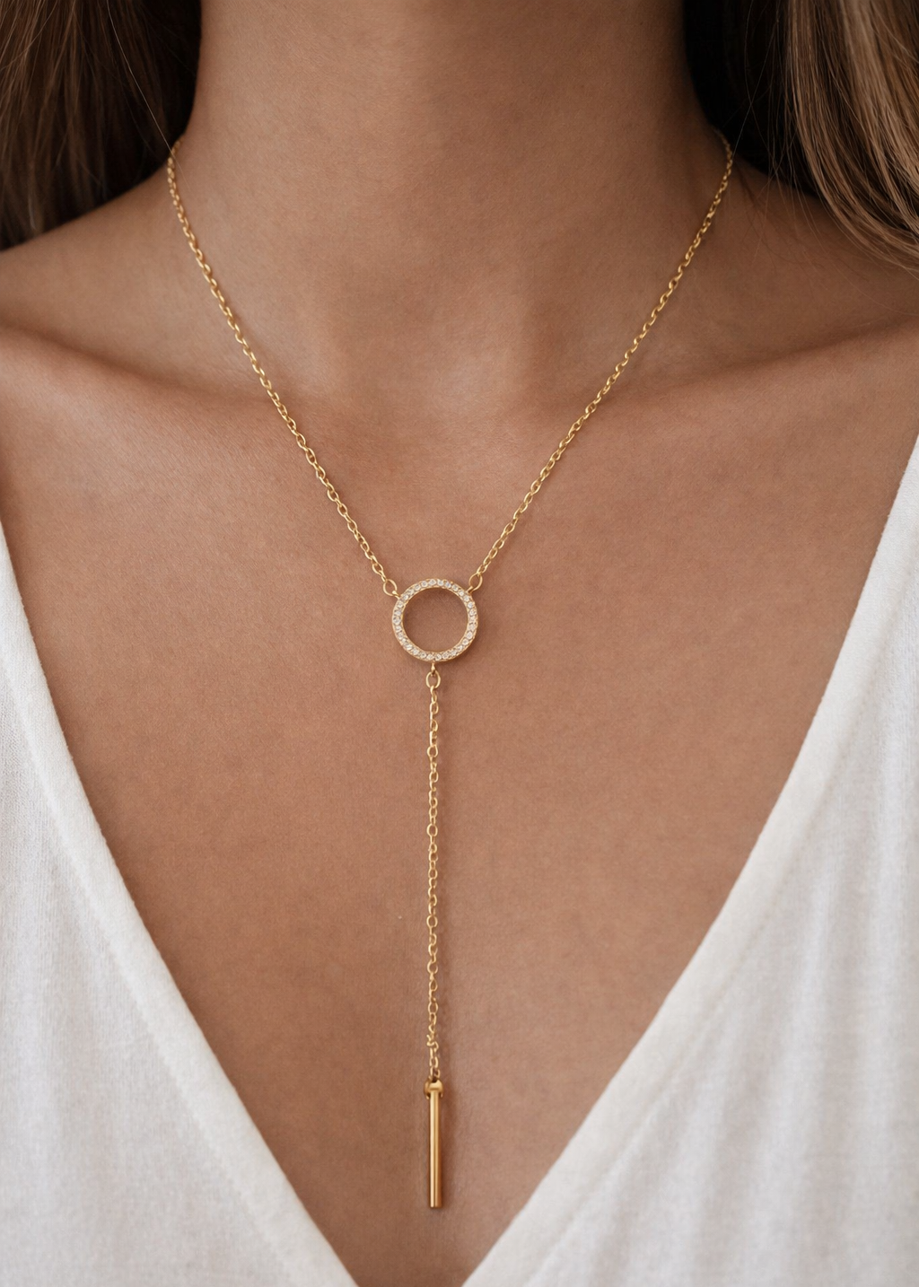 Gold crystal circle lariat necklace with drop chain detail worn on neck, non tarnish water resistant jewellery