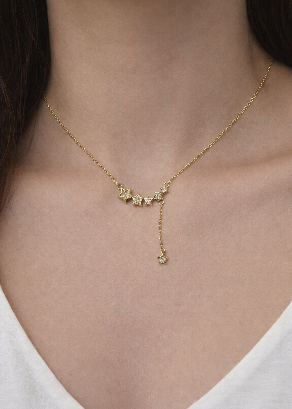 gold star drop necklace with crystal stars and delicate chain detail