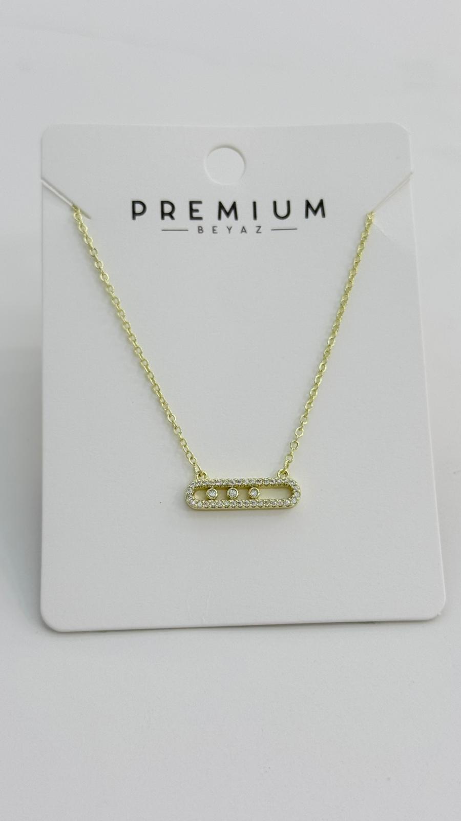 Gold necklace with a bar pendant on a 'Premium Betaz' card against a light gray background