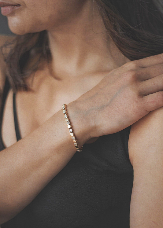 Minimalist gold bracelet with disc and crystal design