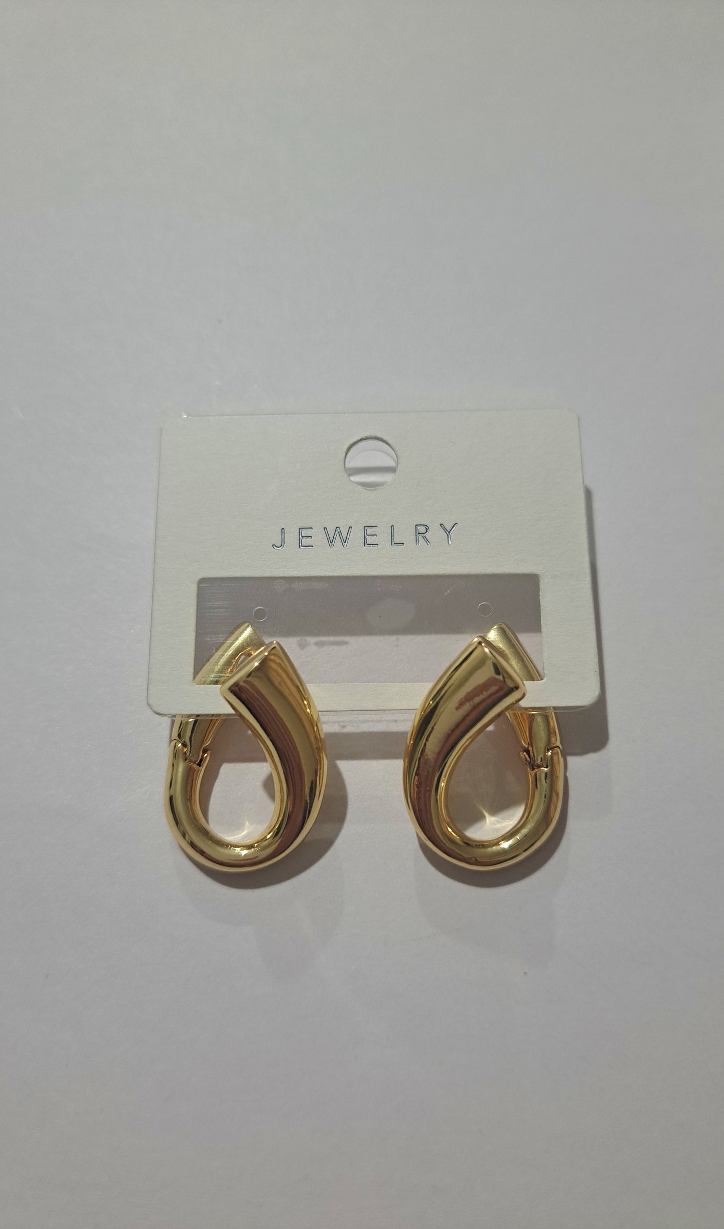 Gold teardrop hoop earrings on display card