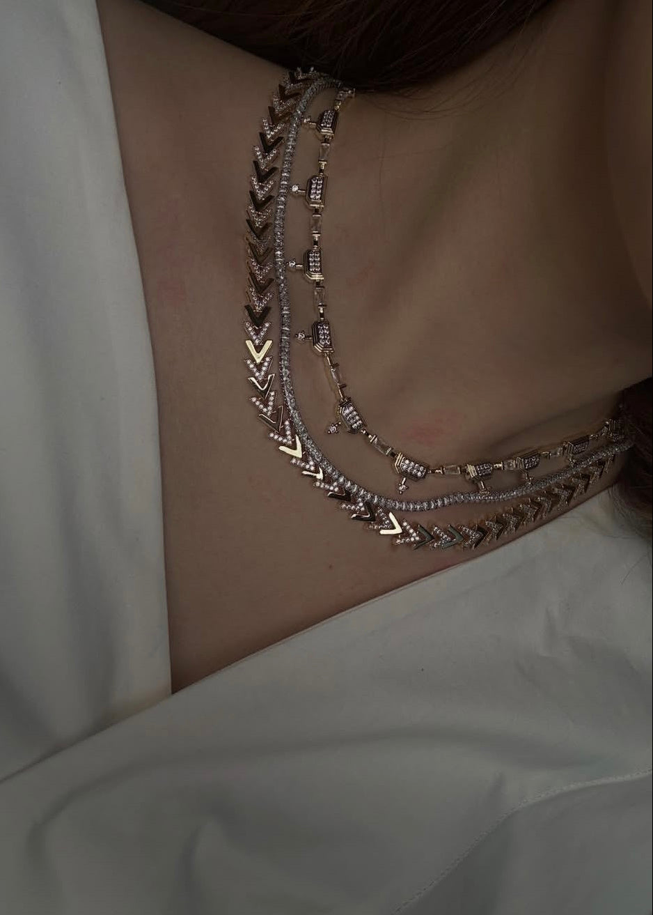 Necklace with geometric design on a plain background