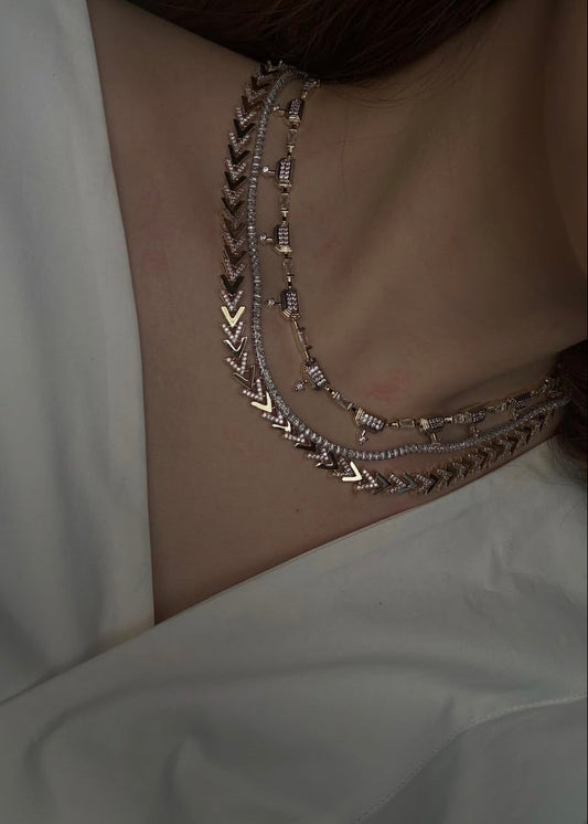 Necklace with geometric design on a plain background