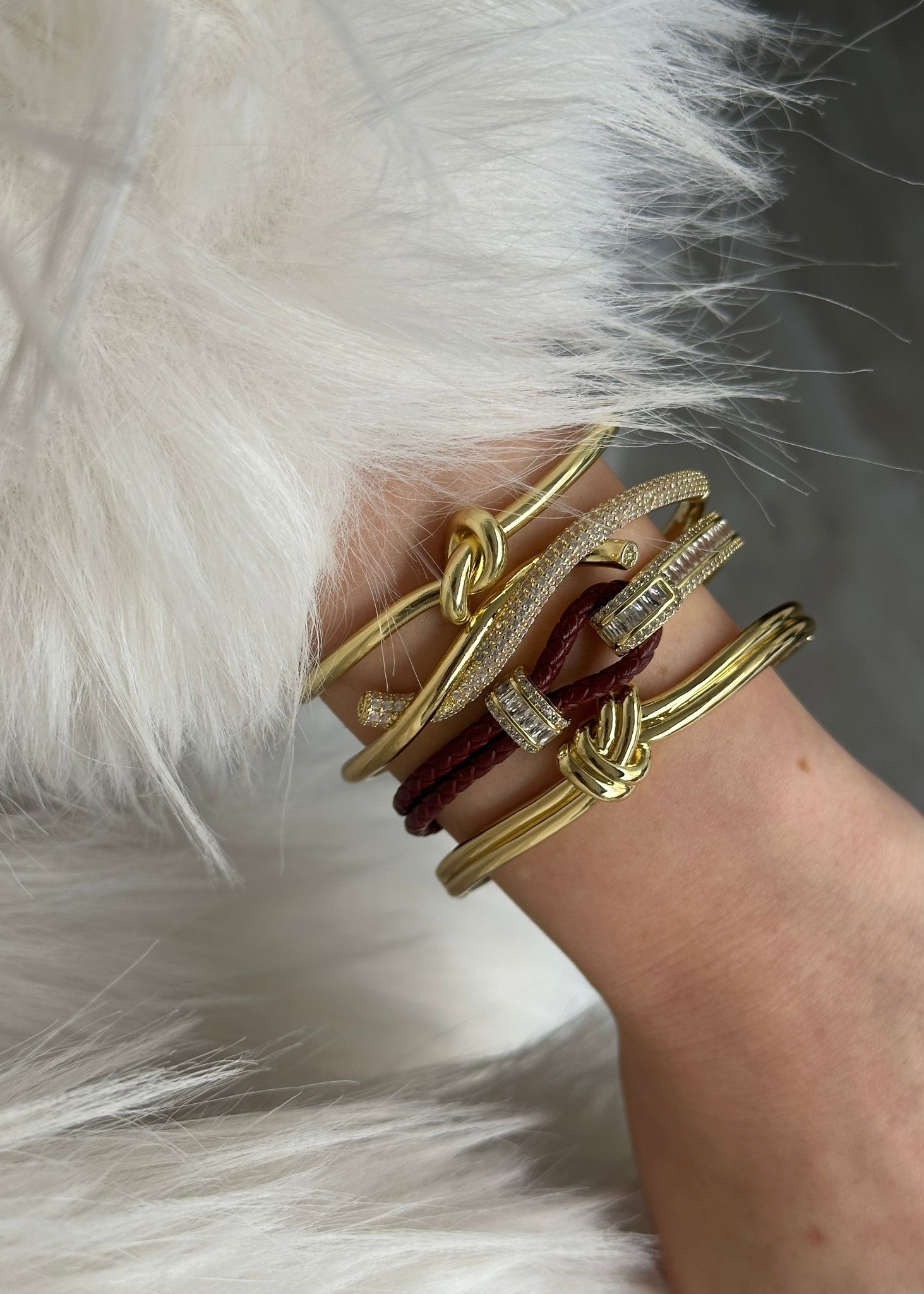 Gold plated bracelet with red braided leather band