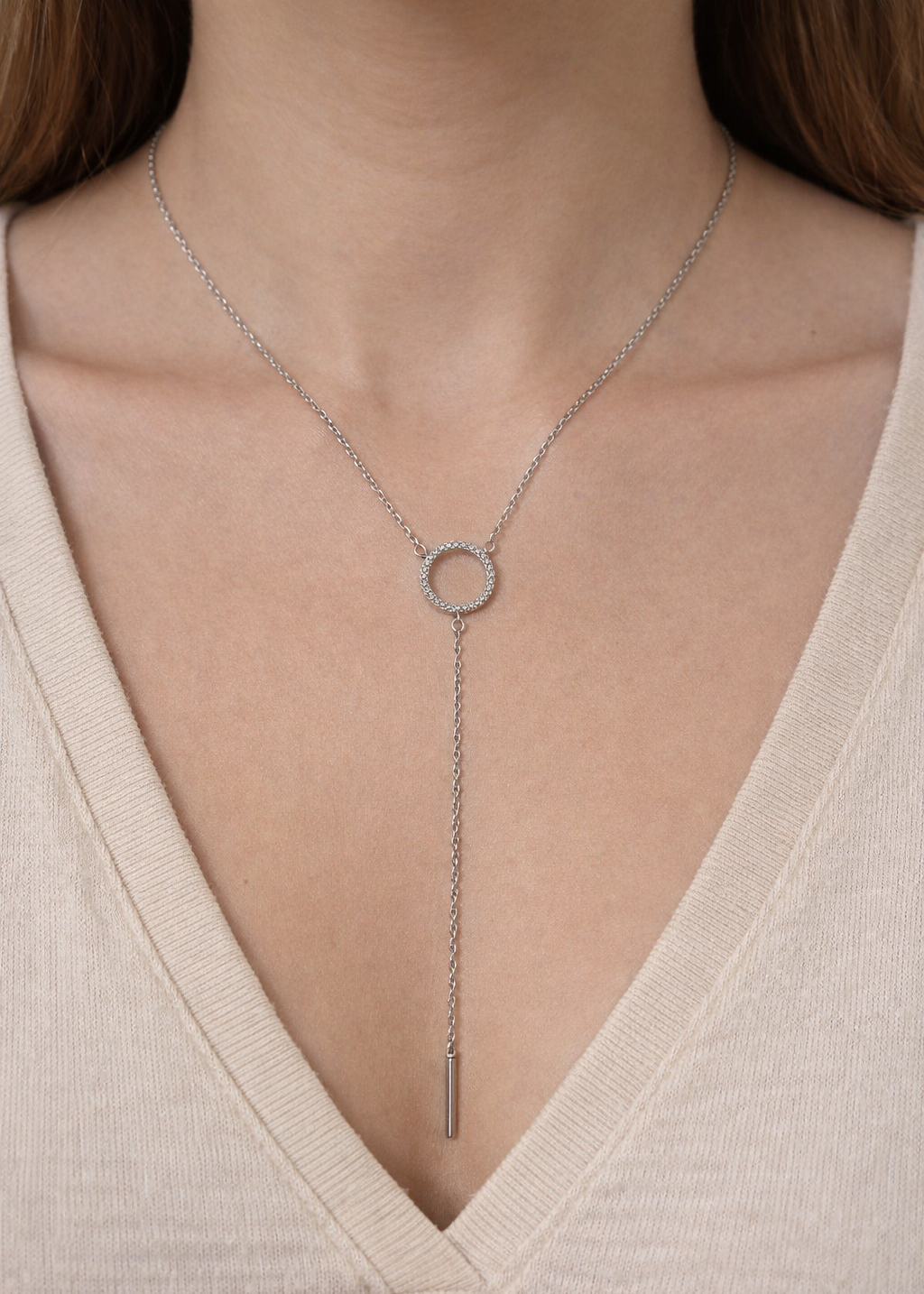 Silver crystal circle lariat necklace with drop chain detail worn on neck, non tarnish water resistant jewellery