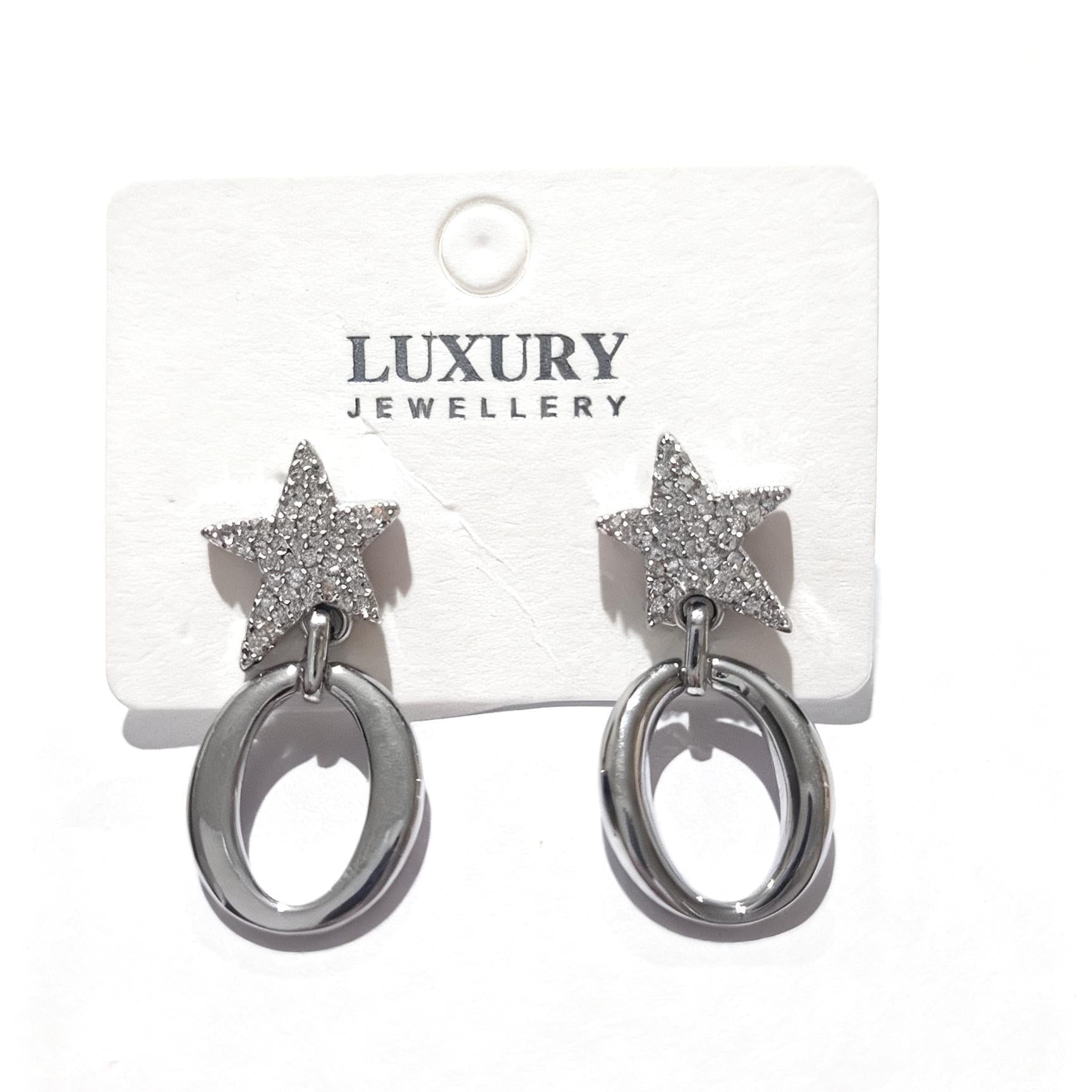 Pair of star-shaped earrings on a Luxury Jewellery card.
