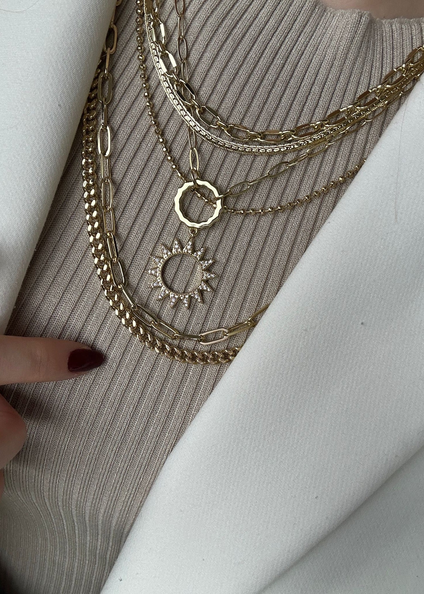 Gold necklaces on a textured surface