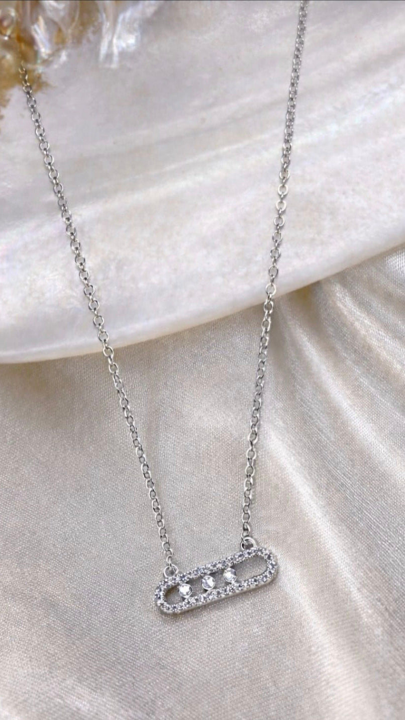 Silver necklace with a pendant on a shell background