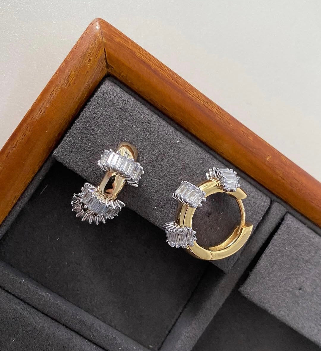Gold and silver hoop earrings in a jewelry box