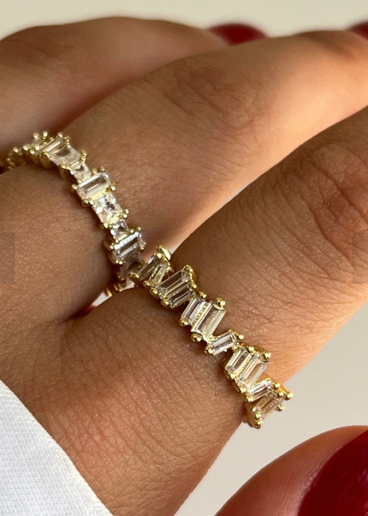 Gold ring with baguette diamonds on a hand
