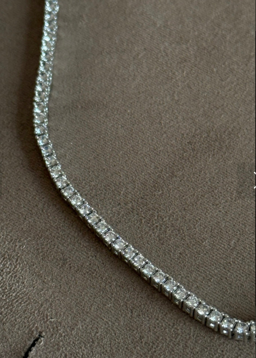 Diamond necklace on a brown textured surface