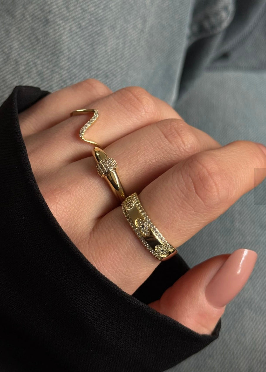 Gold ring on a finger with a neutral background