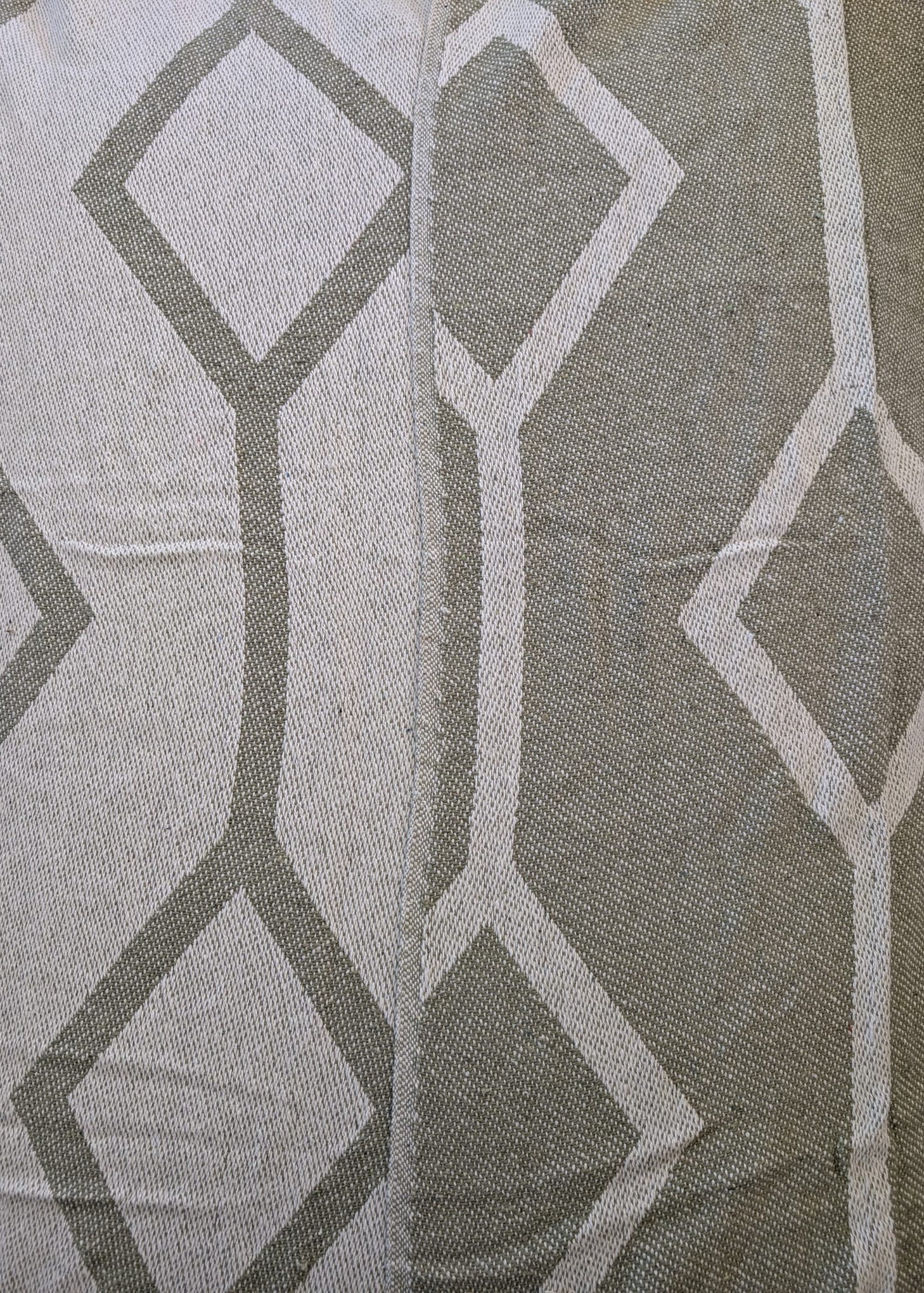 Close-up of fabric with geometric pattern in gray and white