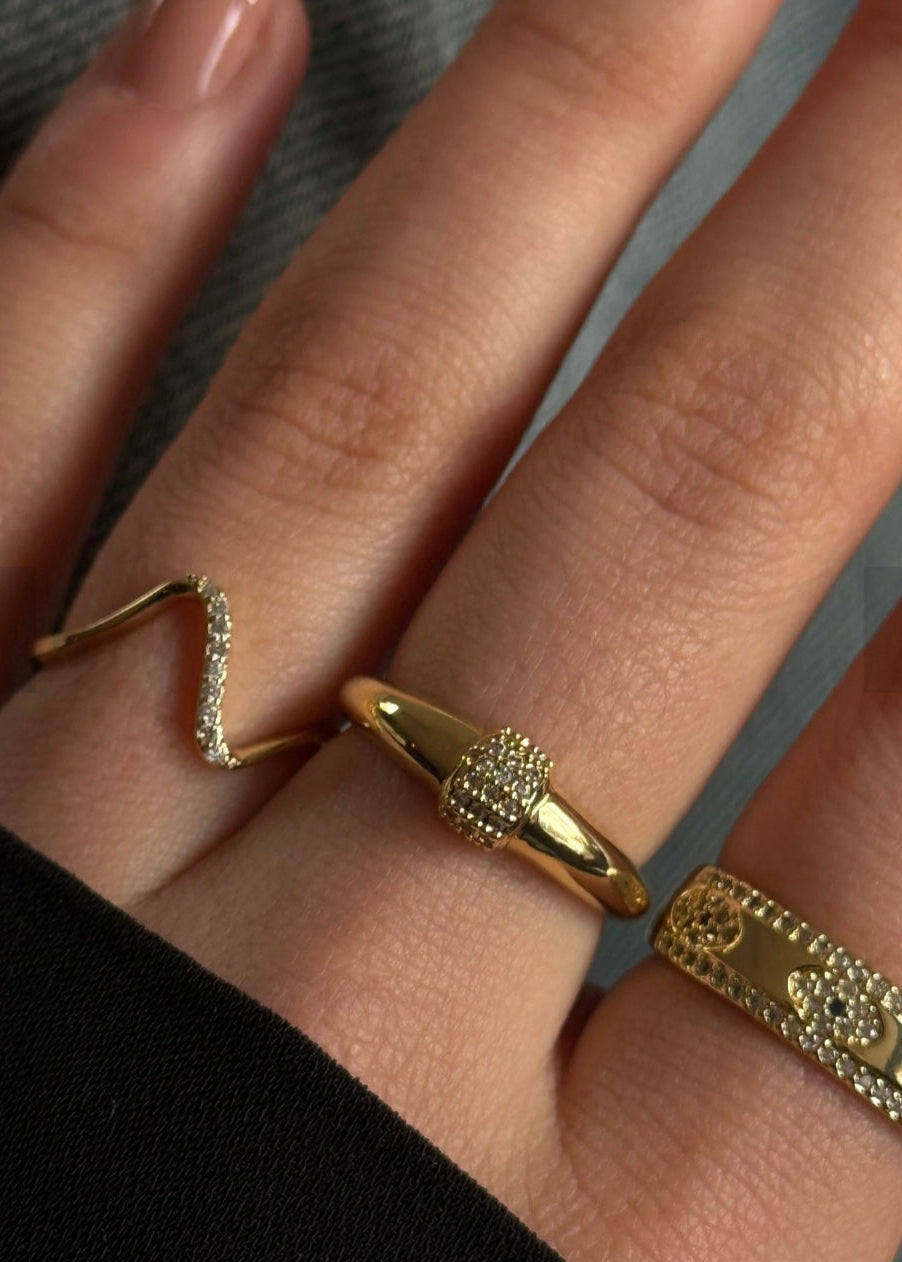 Gold ring on a finger with a blurred background
