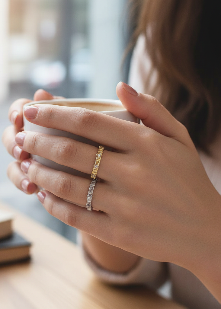 Person holding a mug with rings on a blurred background