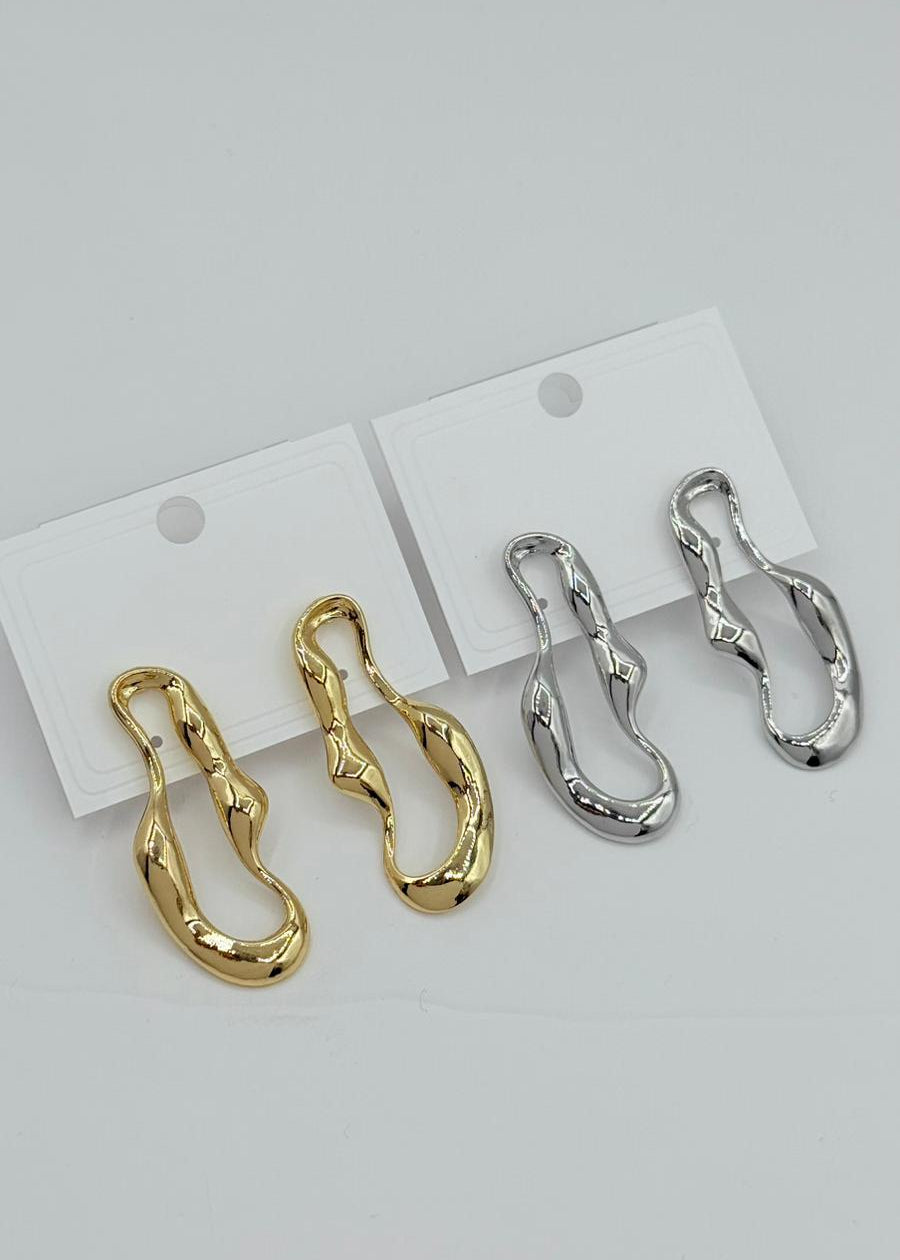 Pair of gold and silver chain-style earrings on white cards against a light gray background.